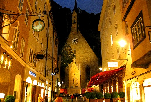 Charming Salzburg street with guild signs at night