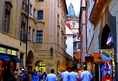 The Astronomical Clock peeks through a narrow Prague street